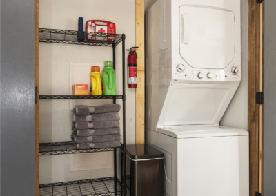Stackable washer/dryer; shelving makes a great pantry space for groceries